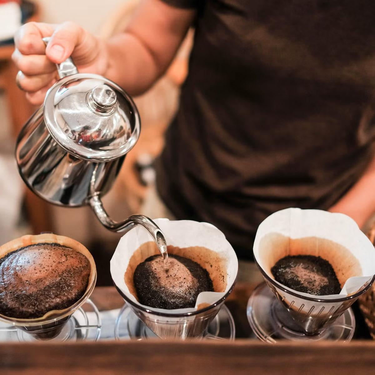 Three cones brewing under a gooseneck kettle